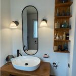 Miroir ovale entourage noir salle de bain